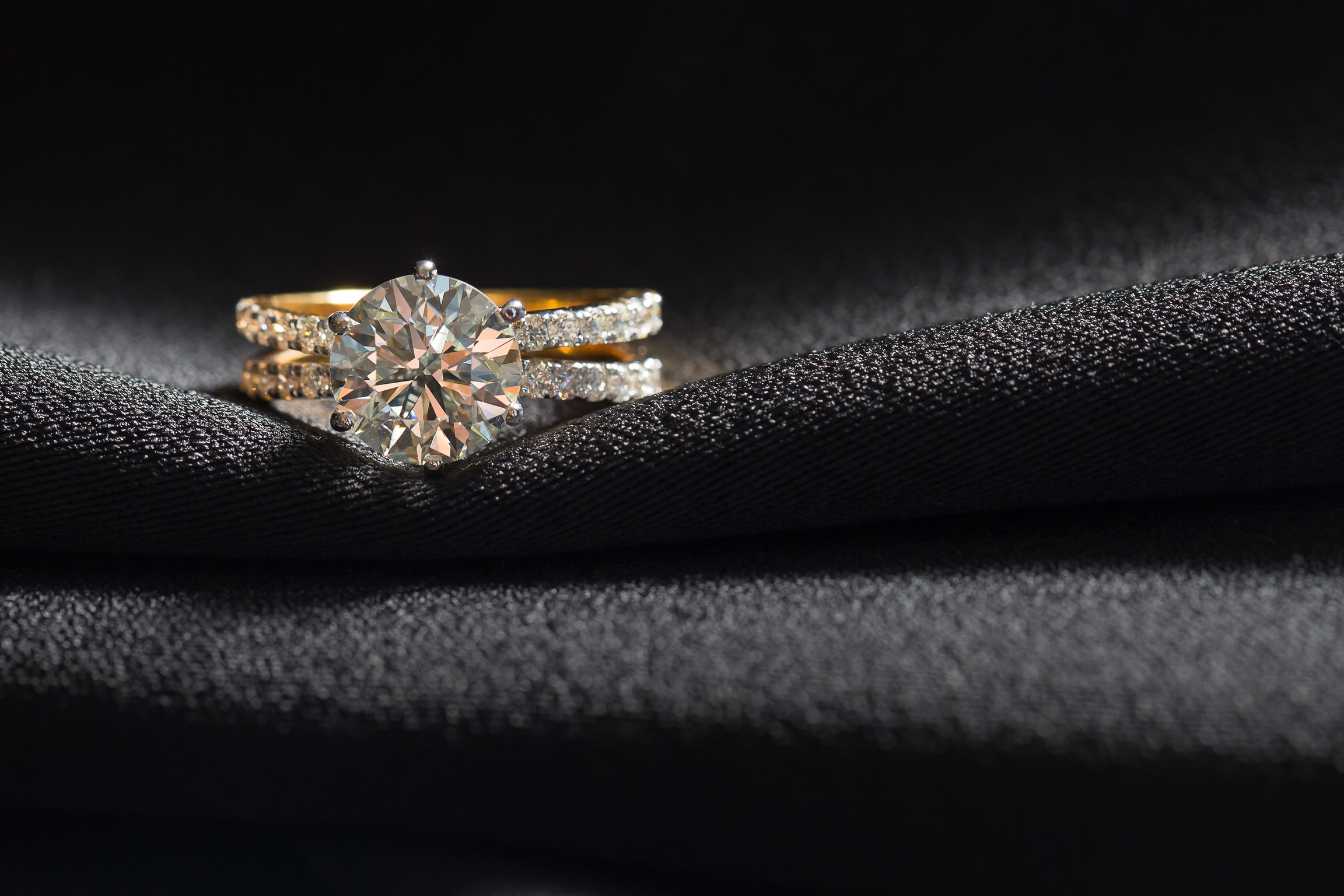 Jewellery ring against black fabric background